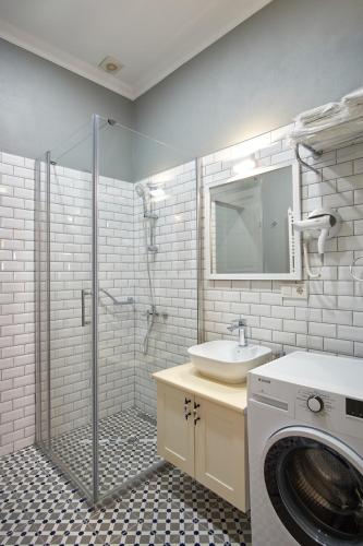 a bathroom with a sink and a washing machine at Nostalgic & Comfortable Historical Home! in Istanbul