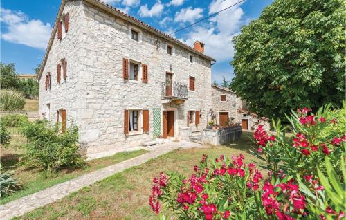 an external view of a stone house with flowers at Holiday Home Markovac 11 in Markovac