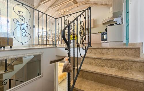 a staircase with a wrought iron gate in a house at Gorgeous Home In Buzet in Buzet