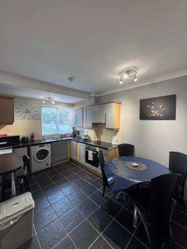 a kitchen with a table and a dining room at Modern Apartment good distance from Dublin City and Airport 4people in Dublin