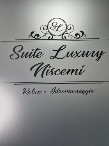 a sign for a luxury elegant restaurant on a wall at Suite Luxury Niscemi in Niscemi