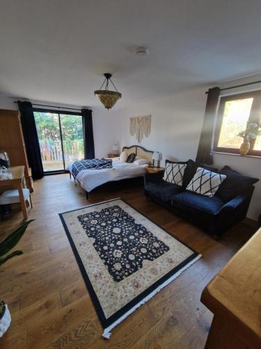 a living room with a couch and a rug at Cedar Lodge in Bowness-on-Windermere