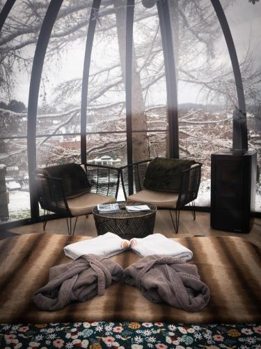 a room with a blanket on the floor in front of a window at La St Hubsphair in Saint-Hubert