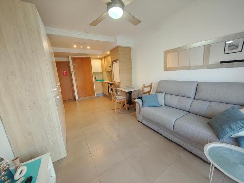 a living room with a couch and a table at Estudio en primera linea de playa in Daimuz