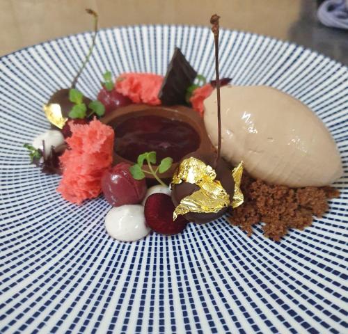 a plate with a dessert with chocolate and nuts at Hotel Restaurant Zur Neroburg in Neroth