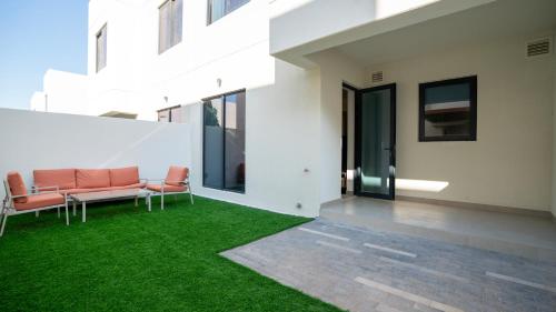 an outdoor patio with green grass in a building at 4br Luxury Villa Yas Island Near F1 in Abu Dhabi