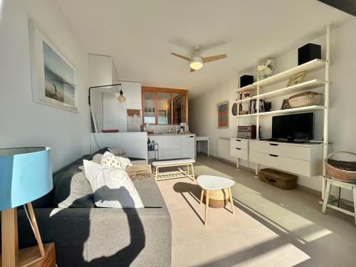 un soggiorno con un divano e un tavolo di Bel appartement vue mer a Palavas-les-Flots