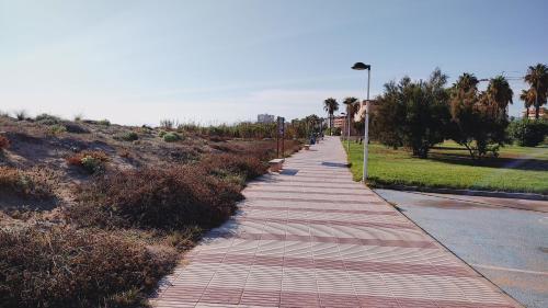 a sidewalk with a red brick on a street at Estudio en primera linea de playa in Daimuz