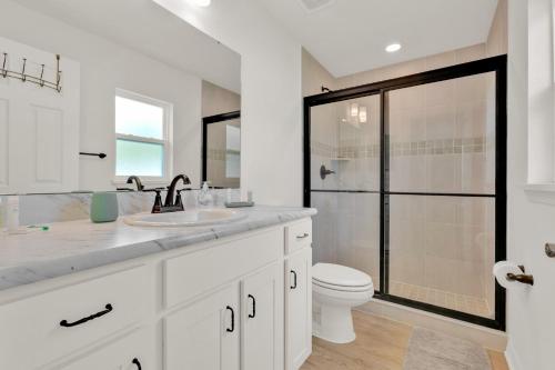 a bathroom with a toilet and a sink and a shower at 3BR House with Backyard & access to Auburndale Trail in Auburndale