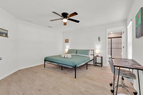 a bedroom with a bed and a ceiling fan at 3BR House with Backyard & access to Auburndale Trail in Auburndale