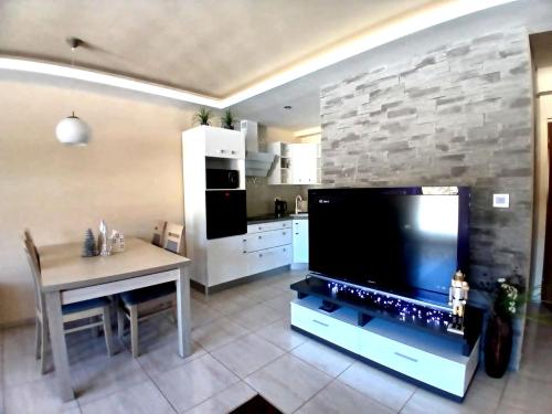 a kitchen with a large flat screen tv in a room at PANORAMA Family Apartment 45C, Donovaly in Donovaly