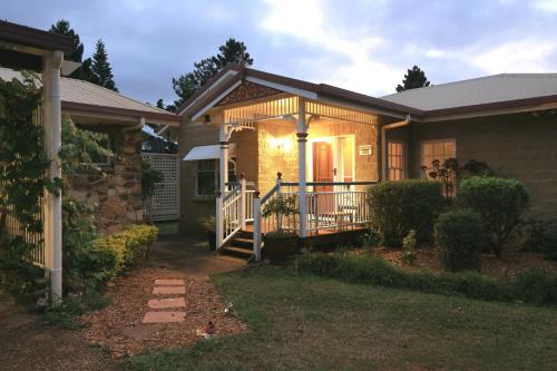 a house with a front porch and a balcony at Lakefront holiday villa in Yungaburra