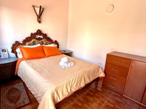 a bedroom with a bed with two towels on it at HOTEL HOSTERIA la PINTADA in Sáchica