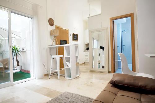 a living room with a couch and a large window at Charming Apartment Málaga 40 m² + Internet in Málaga