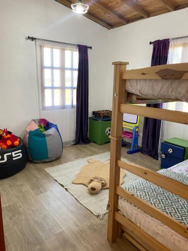 a bedroom with two bunk beds and a window at Villa Nikitina in Los Santos