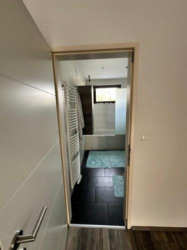 a hallway with a door leading into a room with a staircase at Casa del Retiro in Nebersdorf