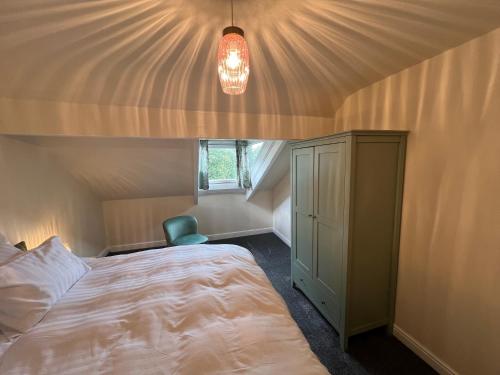 a bedroom with a bed in a room with a ceiling at Prospect House in Settle