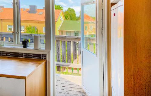 a door to a balcony with a view of a house at 2 Bedroom Amazing Apartment In Visby in Visby