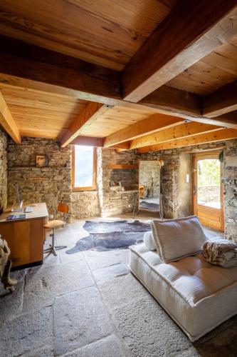 a living room with a couch and a desk at Mas de la Costete in Mons
