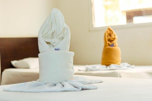 two rolls of towels sitting on a table in a hotel room at Hotel California Air in Carepa