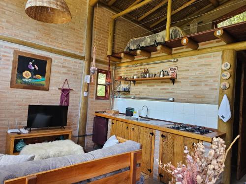 a kitchen with a counter and a stove in a room at Recanto Curiaçu in Cunha