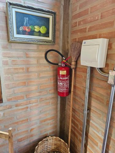 a fire hydrant hanging on a wall with a picture at Recanto Curiaçu in Cunha
