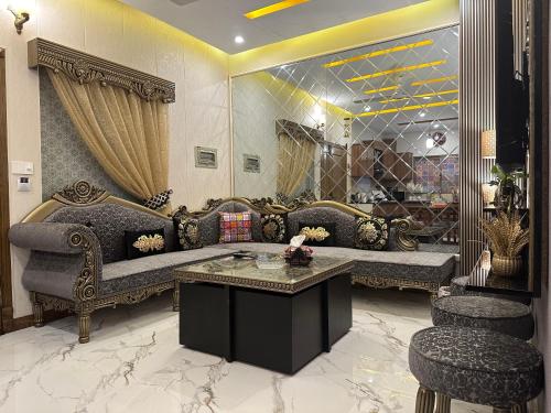 a living room with a couch and a table at Exquisite Luxe 2 Bedroom Condo Close to GIGA MALL in Islamabad