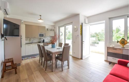 a kitchen and dining room with a table and chairs at Pet Friendly Home In Nocera Terinese in Nocera Terinese