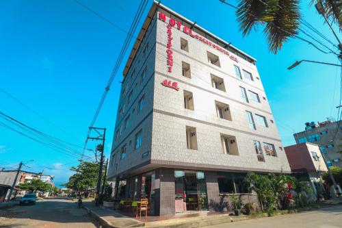 a building with a sign on the side of it at Hotel California Air in Carepa
