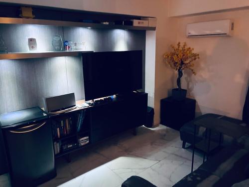 a living room with a desk with a laptop on it at Penthouse Elysium in Mexico City