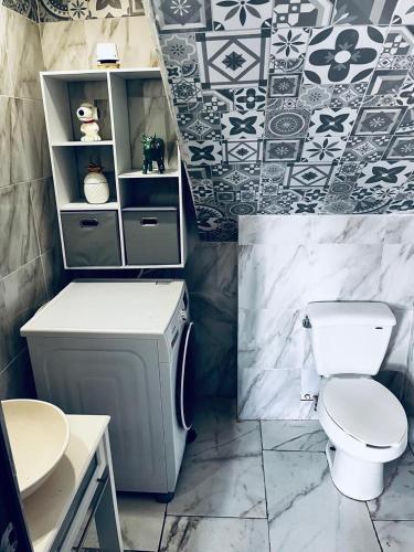 a bathroom with a toilet and a sink at Penthouse Elysium in Mexico City