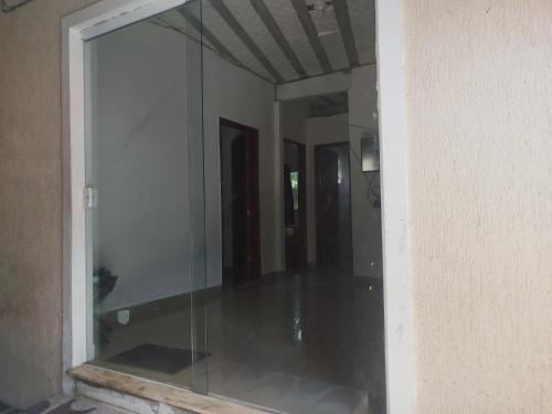 a glass door to a room with a hallway at Recanto do Mauro in Mangaratiba