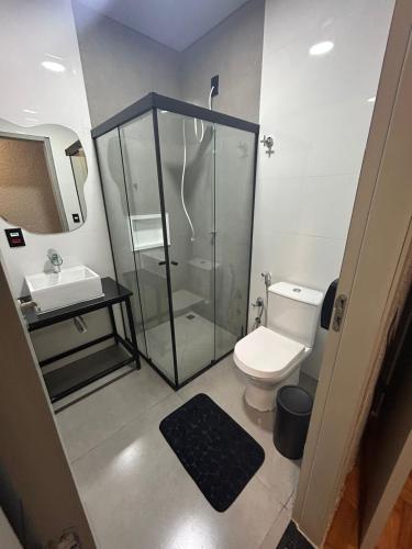 a bathroom with a shower and a toilet and a sink at POUSADA BRAGANTINA Economic in Bragança Paulista