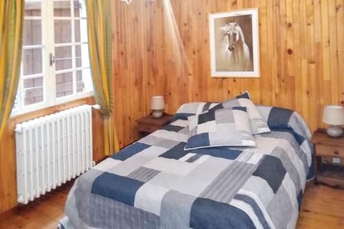 a bedroom with a bed and a horse picture on the wall at Maison charmante au cœur du Chambon-sur-Lignon avec jardin in Le Chambon-sur-Lignon