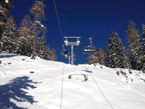 a snow covered ski slope with a ski lift at Hotel Tauplitzerhof in Tauplitz