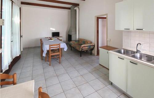 a kitchen with a table and a dining room at Lovely Apartment In Rosolina Mare in Rosolina Mare