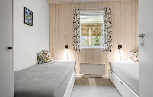a bedroom with two beds and a window at Beautiful Home In Spøttrup With Wifi in Spottrup