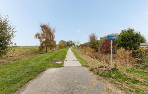 a dirt road with a street sign on the side at 2 Bedroom Cozy Home In Wagenborgen in Wagenborgen