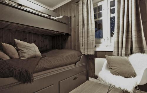 a bed in a small room with a window at Amazing Home In Gålå With Sauna in Gålå
