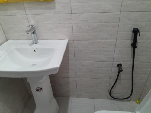 a bathroom with a sink and a shower at Valley Breeze Hotel in Dar es Salaam
