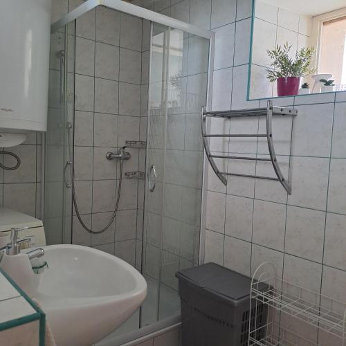 a bathroom with a shower and a sink at Tünde lak in Siófok