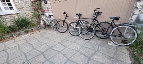 a group of bikes parked next to a garage at A la belle Etoile de Paris à Honfleur in Cravent