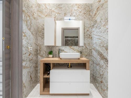 a bathroom with a sink and a mirror at BellaVita Apartments in Assemini