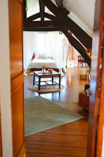 a bedroom with a bed and a table on the floor at A la belle Etoile de Paris à Honfleur in Cravent