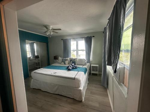 a bedroom with a bed and a ceiling fan at Playa Esmeralda suite 4 in Bradenton Beach