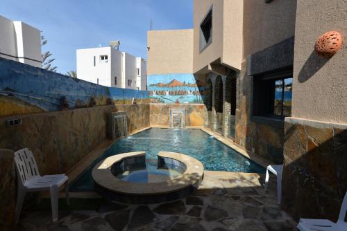 a swimming pool in the middle of a building at Tirazir House 3 in Mirleft