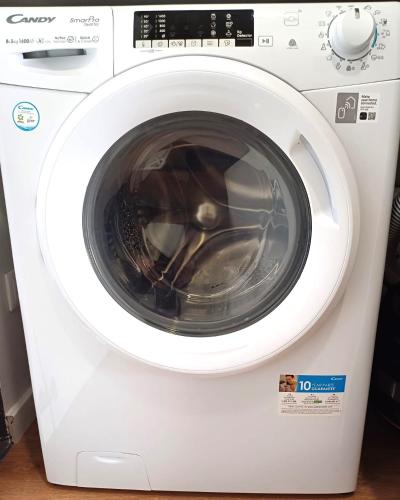 a white washing machine with its door open at Alameda Apartments in Trofa