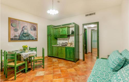 a living room with a table and green cabinets at Beautiful Apartment In Orosei With Wifi in Orosei