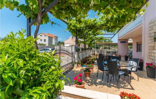 a patio with a table and chairs and plants at Amazing Apartment In Biograd Na Moru in Biograd na Moru