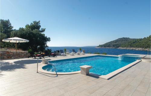 a swimming pool with a view of the water at Holiday Home Poplat 19 in Vela Luka